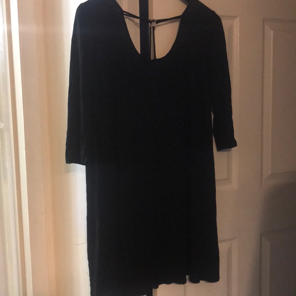 Black dress with gold ring in-front.